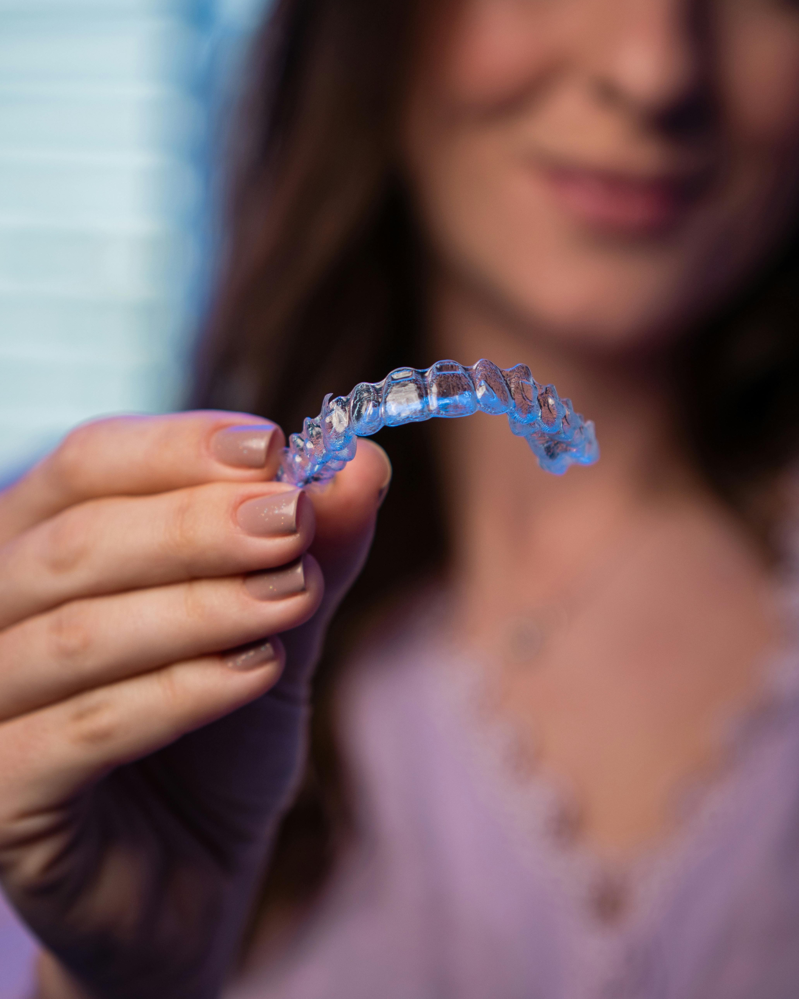 Patient holding clear aligner