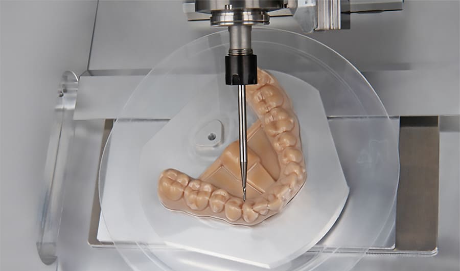 Dental milling machine creating aligners